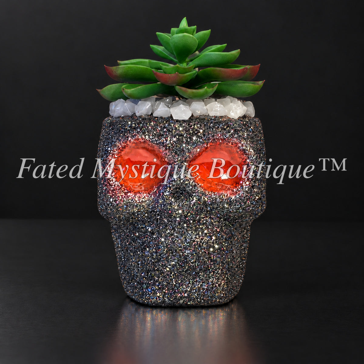 Black glow-in-the-dark skull artificial succulent planter with orange glowing eyes — Fated Mystique Boutique