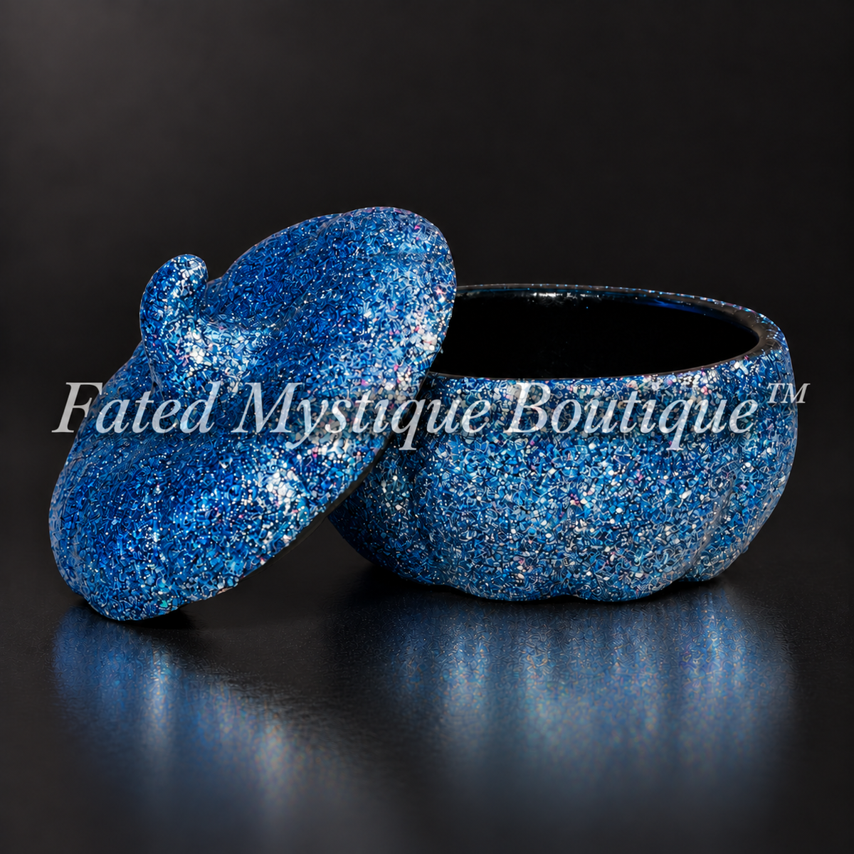 Dark blue glitter pumpkin trinket jar shown open with its matching lid on a charcoal studio background.