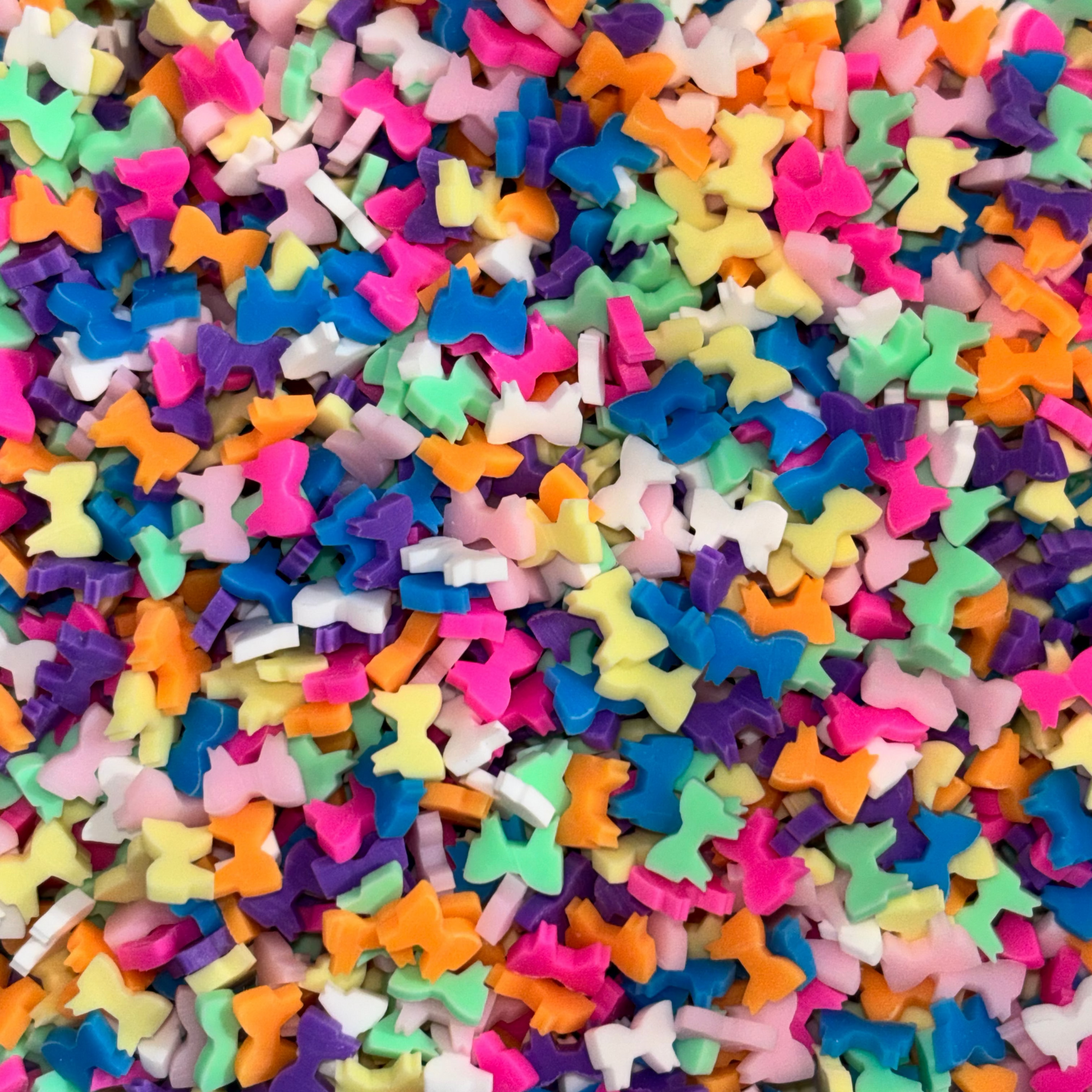 Colorful star-shaped sprinkles in various sizes and colors.