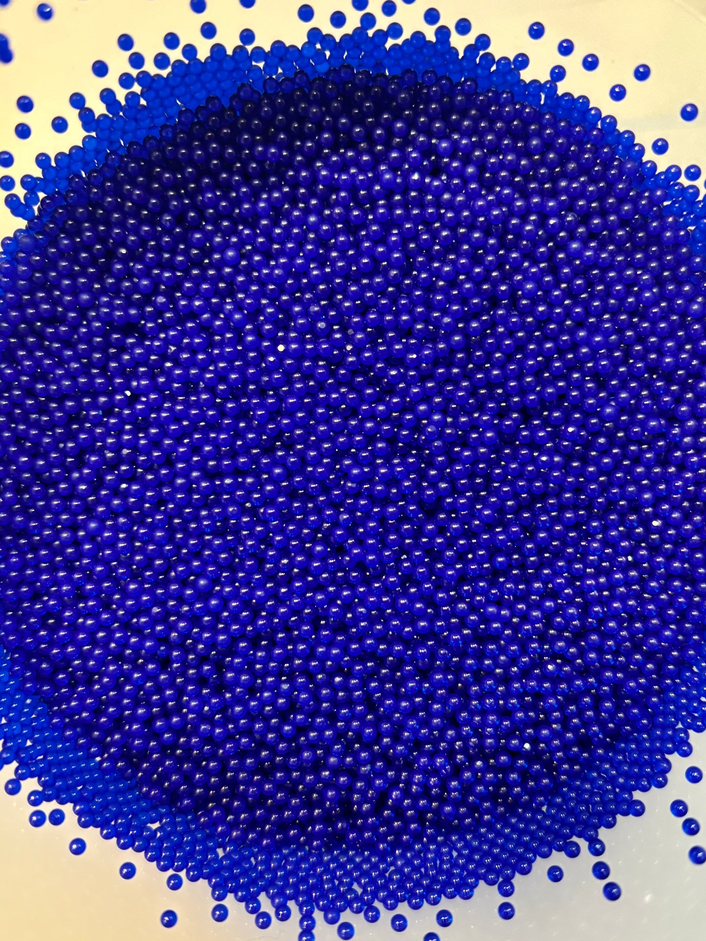 Close-up of blue beads on a beige background