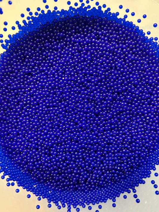 Close-up of blue beads on a beige background