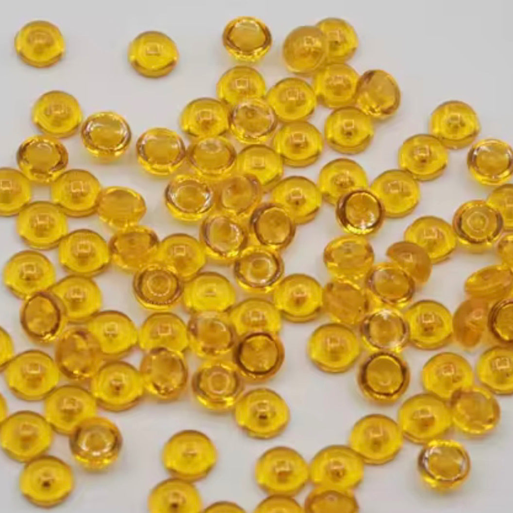 Yellow gemstones scattered on a white background