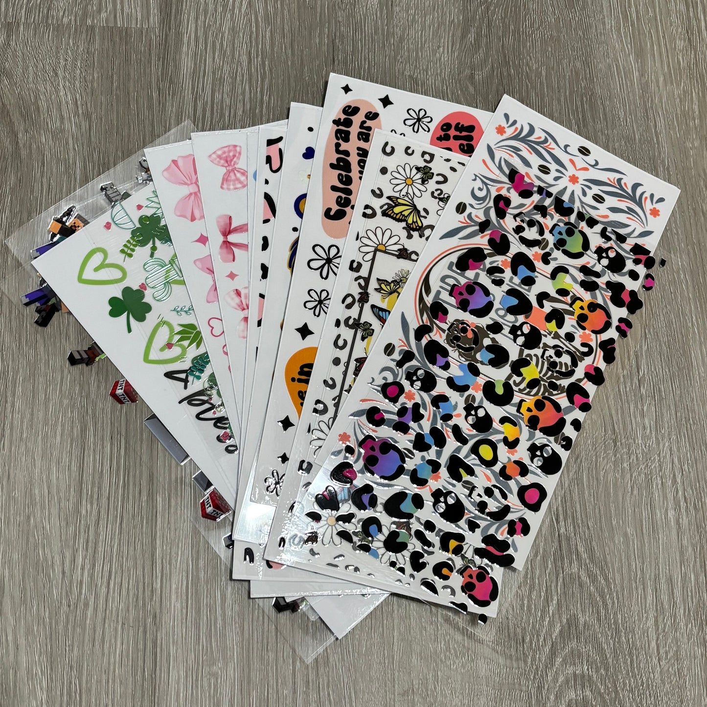 Collection of colorful stickers on a wooden surface