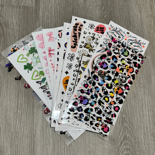 Collection of colorful stickers on a wooden surface