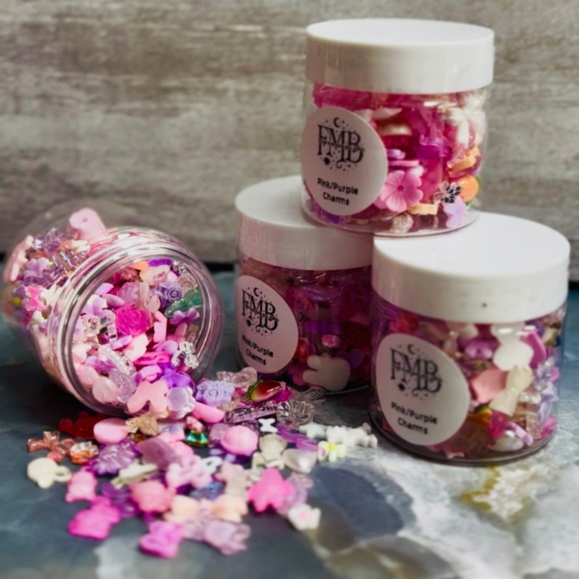 Jars of pink and white decorative confetti on a textured surface