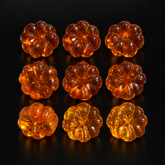 Amber Pumpkin Charms, 9 pieces clearance pack, shown on a black studio background