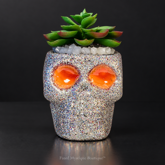 Silver glow-in-the-dark skull artificial succulent planter with glowing eyes — charcoal studio mockup