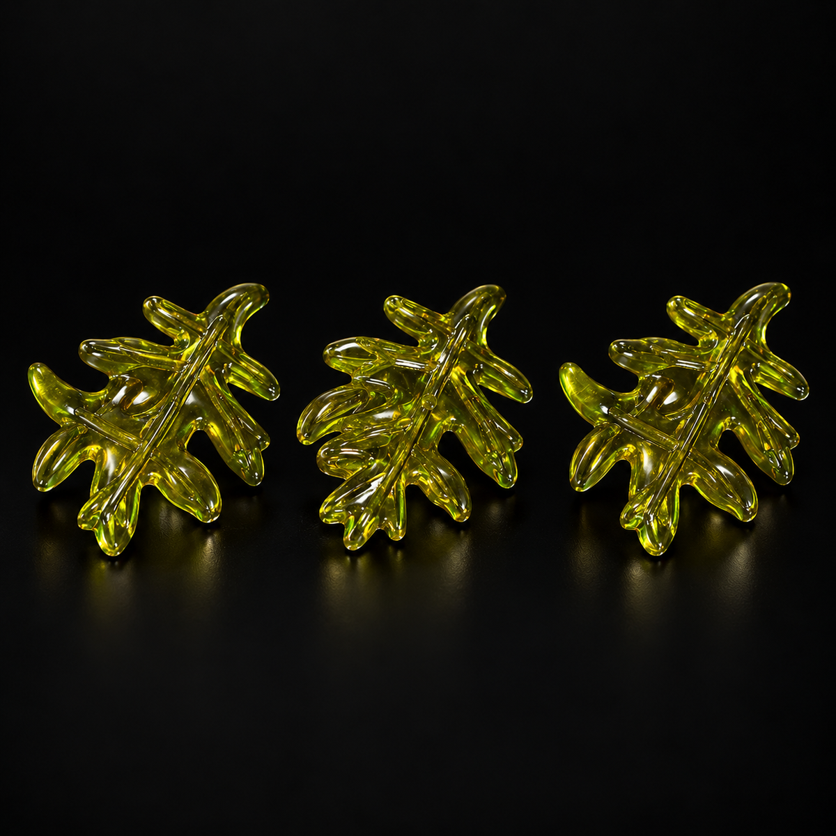 Green Leaf Charms, 3 pieces clearance pack, shown on a black studio background
