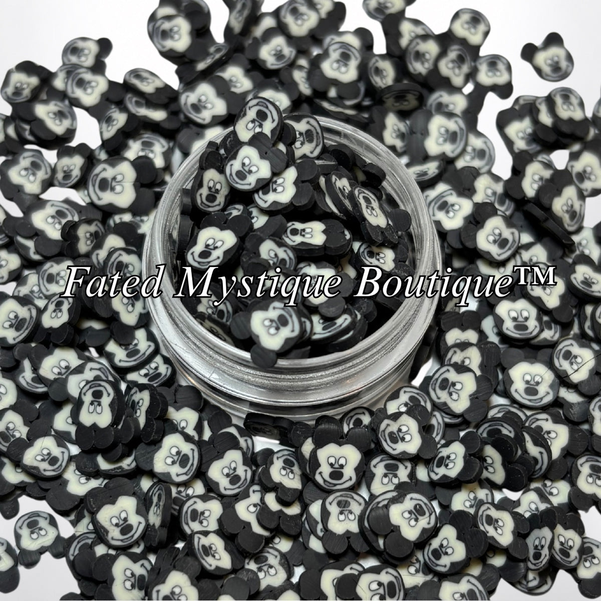 Mickey polymer clay slices displayed in a clear jar with loose slices on a white background