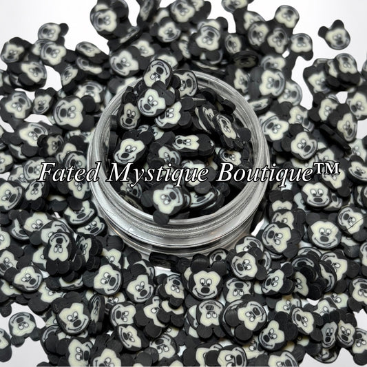 Mickey polymer clay slices displayed in a clear jar with loose slices on a white background