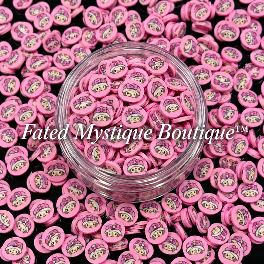 Strawberry Shortcake polymer clay slices in a clear jar with loose slices on a black background
